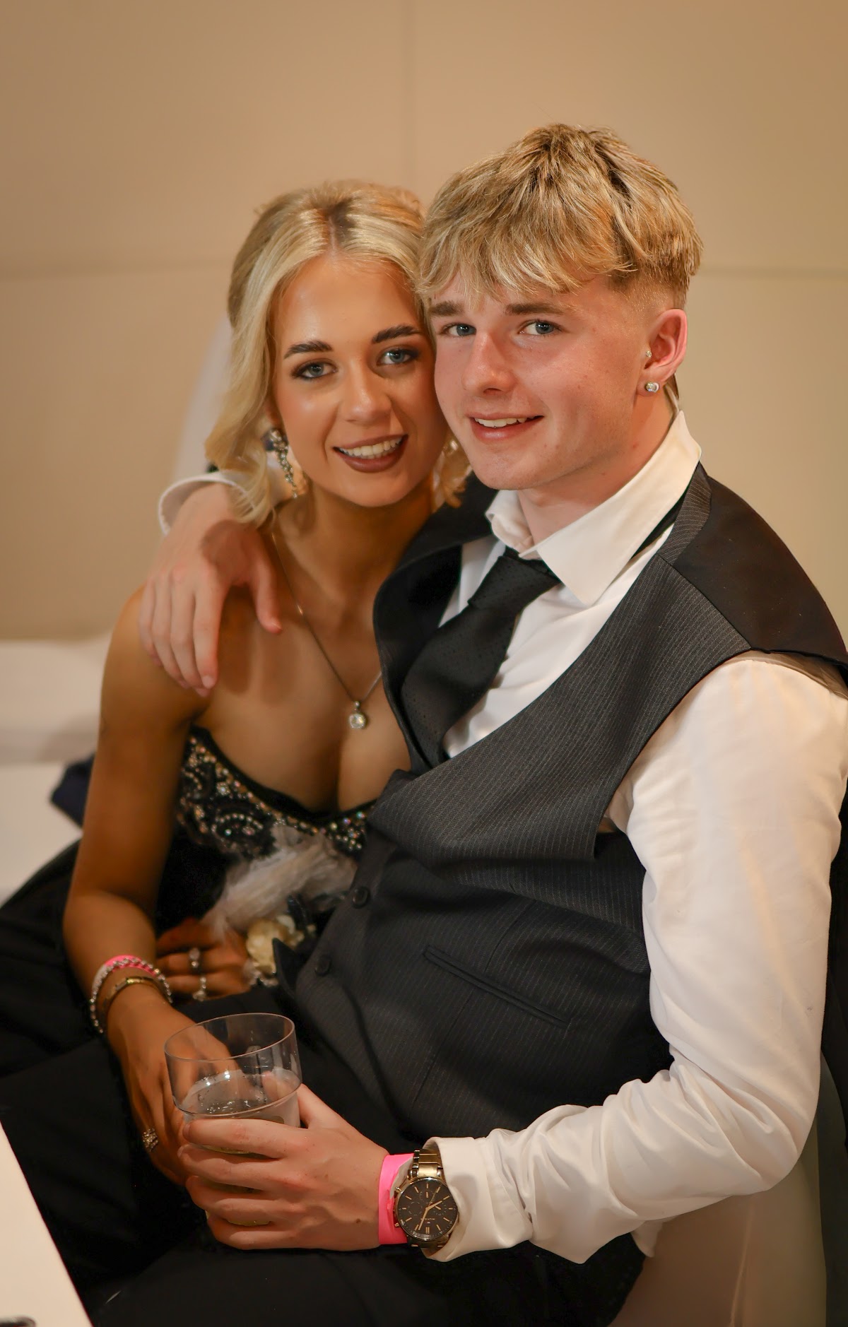 A couple smiling for a portrait at their Debs
