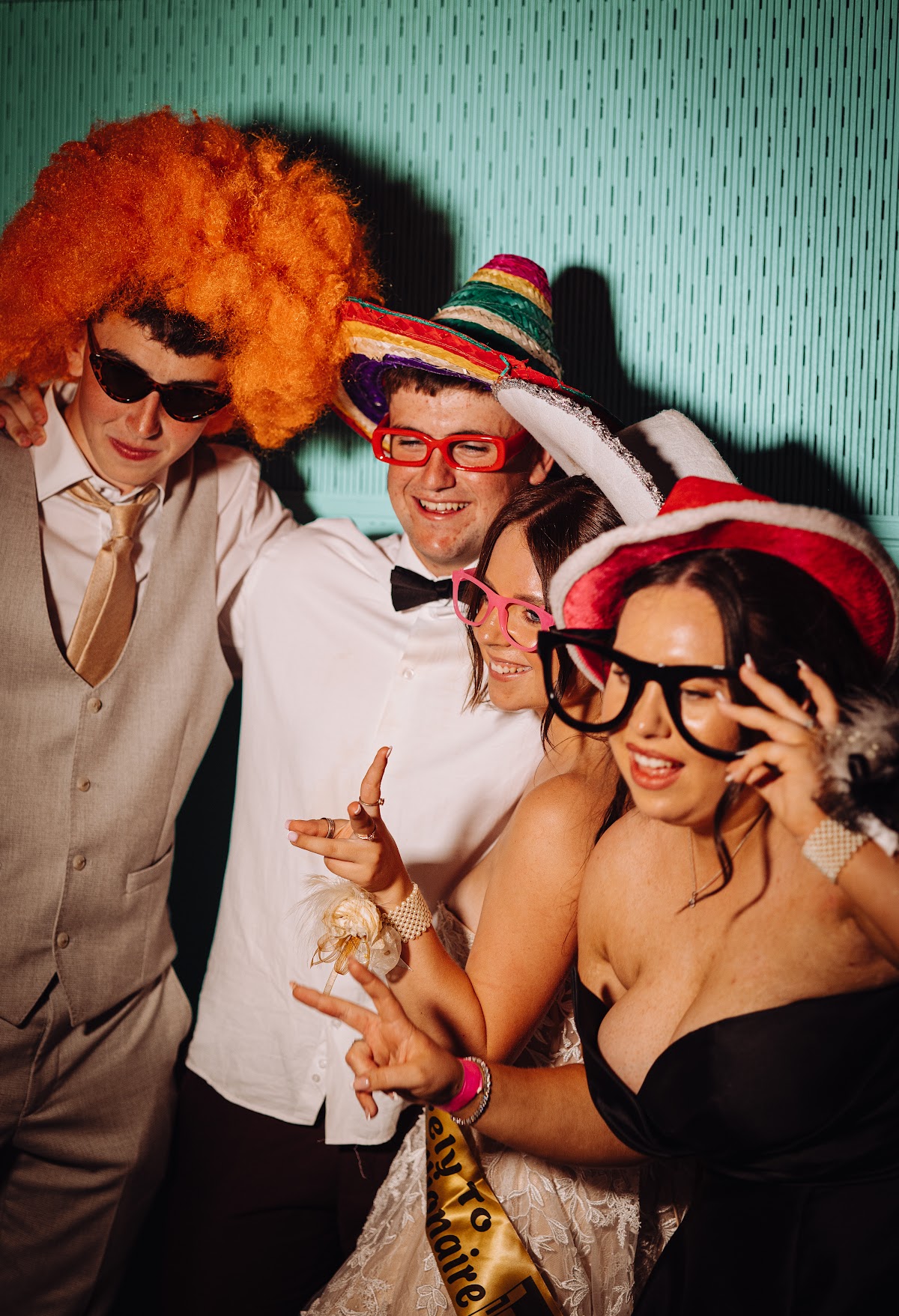 A group of friends laughing together in the photobooth
